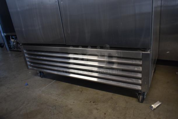 Commercial stainless steel refrigerator on wheels, louvered vent, minor surface scratches, used condition.
