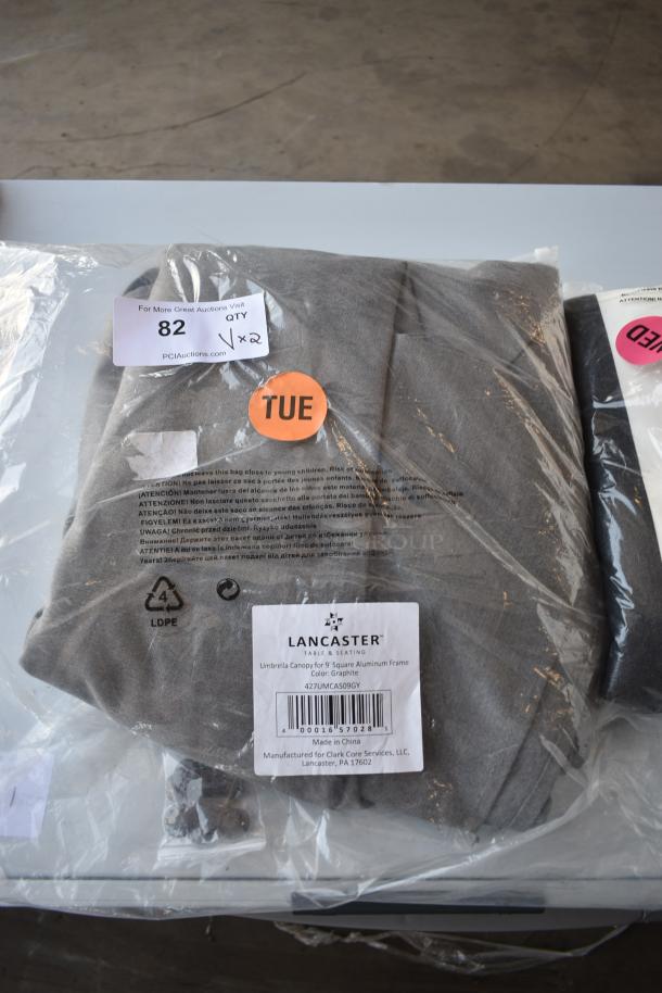 Lancaster Table Seating 9' square umbrella canopy, graphite color, in original packaging. Includes label with product details.