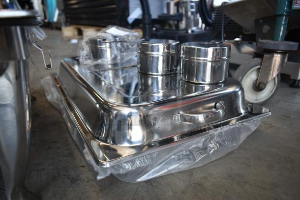 Stainless steel chafing dish set with lids, new condition, includes multiple containers, still in plastic packaging.