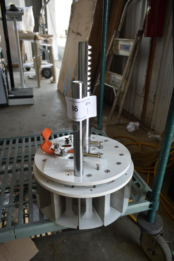 Industrial machine component with metal cylinder, adjustable orange lever, and multi-hole base. Auction tag reads "86".