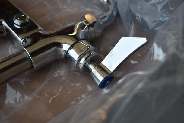 Chrome faucet with lever handle, new condition, wrapped in plastic. Features sleek design and quality finish, no visible brand.