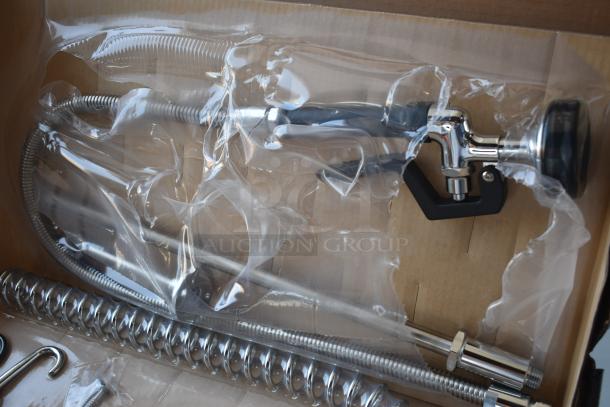 Commercial pre-rinse faucet in packaging with stainless steel hose and spring. New condition, unassembled in box.