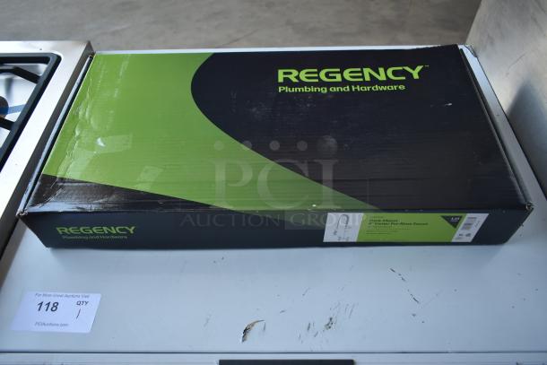 Regency deck-mount pre-rinse faucet in original packaging. Box shows minor wear. Model and specs visible on label.
