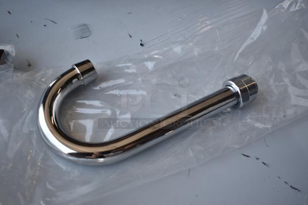 Chrome-plated U-bend pipe in new condition, wrapped in clear plastic. Ideal for plumbing applications.