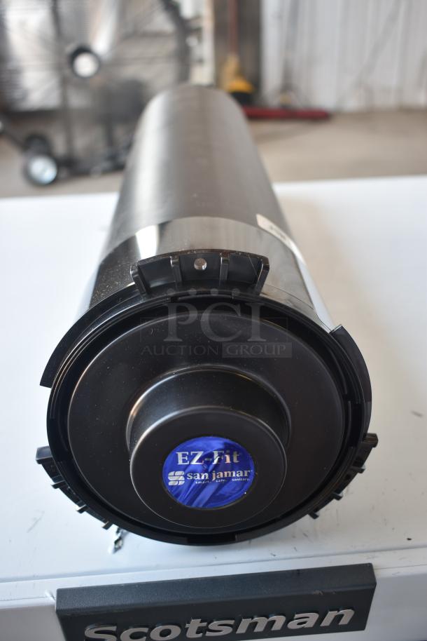 San Jamar EZ-Fit black cup dispenser, cylindrical, with visible label indicating brand and model, in good condition.