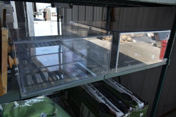 Clear plastic storage drawers with wooden knobs on metal shelving, in excellent condition.