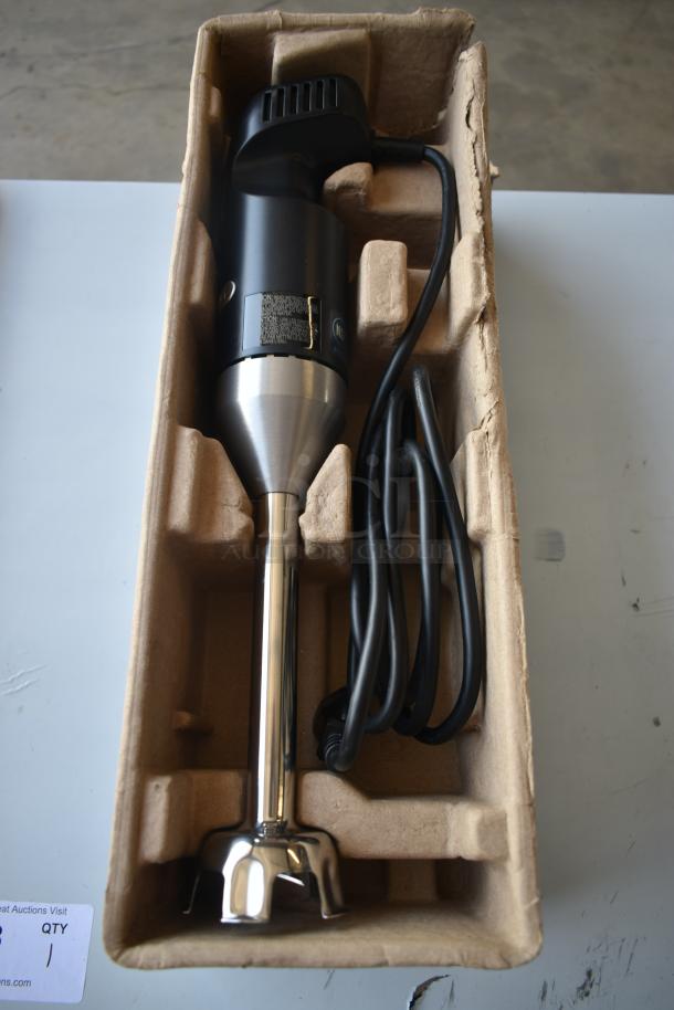 Stainless steel hand blender in protective packaging. Black handle, cord included, appears new with control label visible.