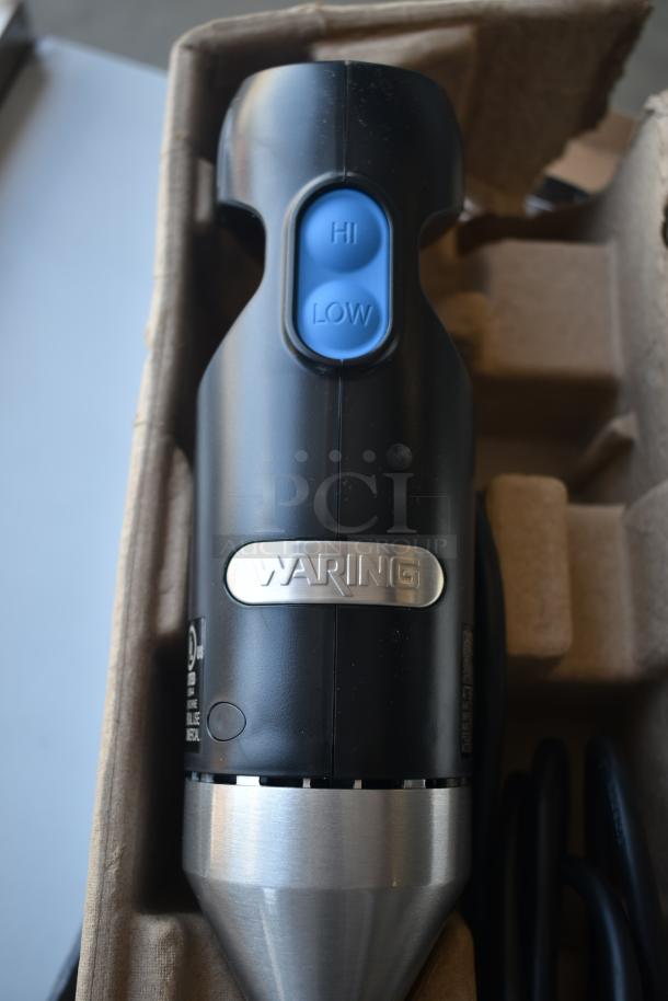 Waring hand blender in black with stainless steel accent, featuring "Hi" and "Low" buttons. Appears in new condition in packaging.