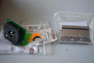 Blodgett OEM parts, including a circuit board and metal component, in bags. Tags show part numbers and barcodes.