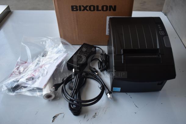 Bixolon thermal printer in new condition with power adapter, cables, and paper roll. Original packaging included.
