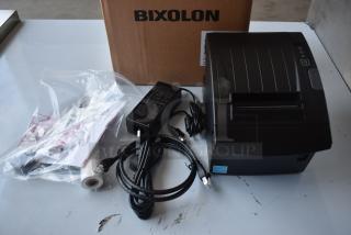 Bixolon thermal printer in new condition with power adapter, cables, and paper roll. Original packaging included.