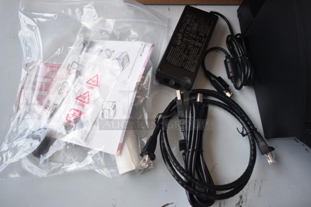 Thermal receipt printer set with power adapter, cables, and instructions. Appears in new condition, with packaging.