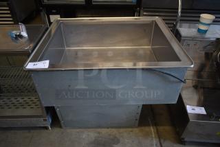 Stainless steel industrial sink with visible wear, auction tag marked "Lot 97," sturdy construction, suitable for heavy-duty use.