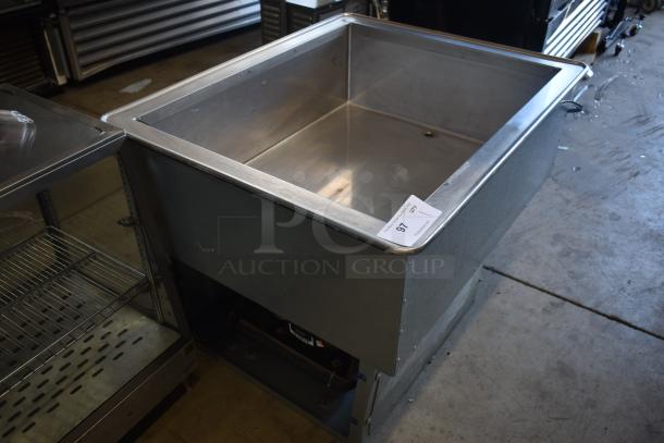 Stainless steel commercial sink with open base, slight wear, auction tag visible with number 97, ideal for restaurant use.