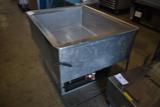 Commercial stainless steel heated well, used condition, with visible wiring and components. Ideal for kitchens. No visible labels.