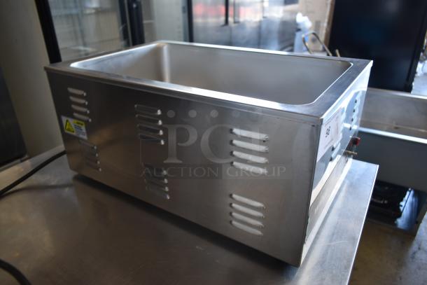 Stainless steel commercial food warmer, excellent condition, vented sides, auction tag number 93, safety warning label.