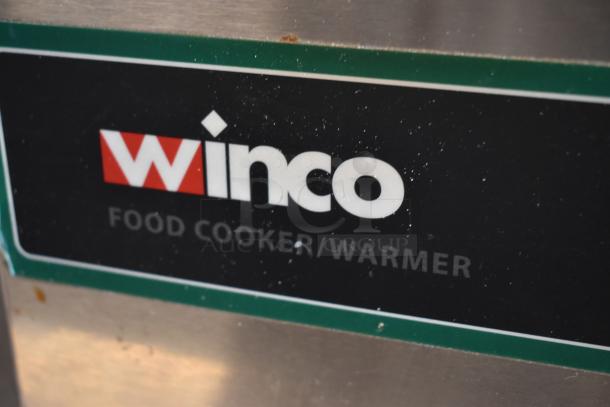 Winco food cooker/warmer, stainless steel. Shows slight wear. Brand label visible on equipment.