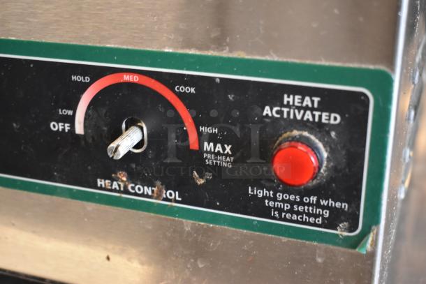 Close-up of a heat control panel with a dial for settings and a red "Heat Activated" button, showing signs of wear.