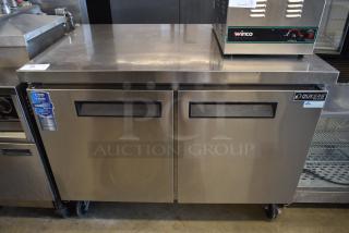 Dukers stainless steel commercial refrigerator, two-door, visible warranty label. Condition: good. Includes Winco food warmer on top.