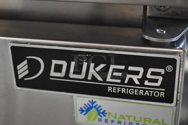 Dukers refrigerator label, showing brand logo on stainless steel. Additional "Natural Refrigerant" sticker visible.