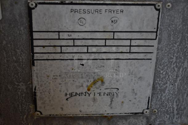 Henny Penny pressure fryer label with UL and NSF certifications, indicating quality standards. Worn condition.