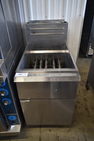 Commercial stainless steel charbroiler with roller grates, moderate wear, auction lot tag 102 attached.