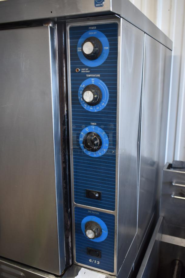 Commercial oven with stainless steel exterior. Features power, temperature, timer, and gas shutoff dials. Model 6/13. Good condition.