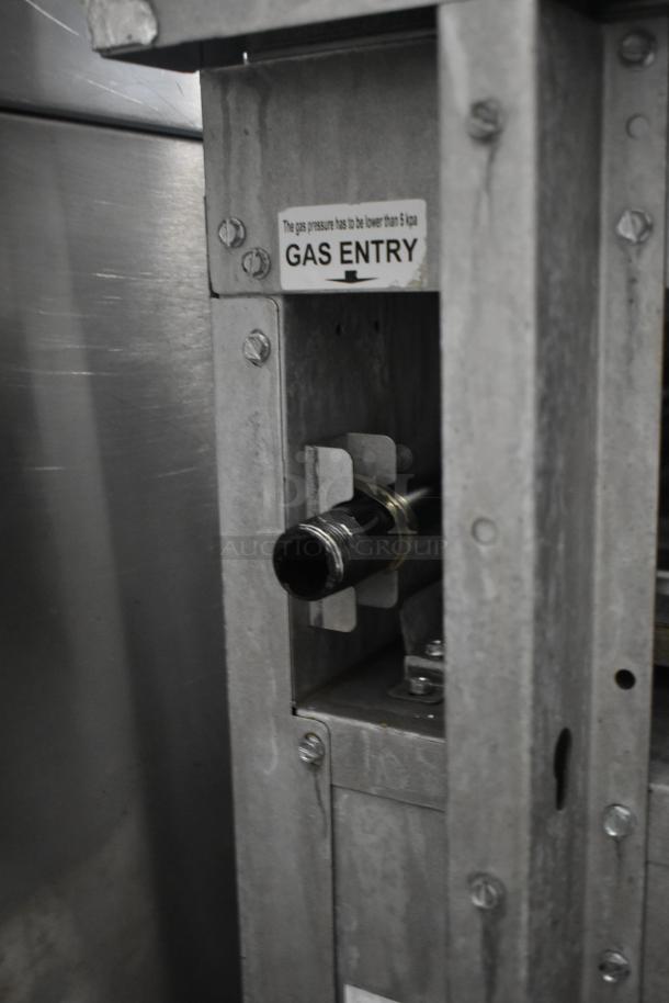 Metal gas entry panel with a black pipe connection and warning label "Gas Entry, pressure below 5 kpa," in good condition.