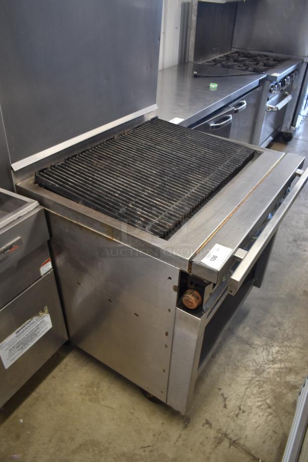 Commercial stainless steel grill, used condition, large ribbed grilling surface, visible temperature dial, auction tag number 108.