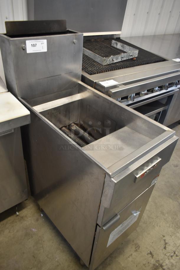 Commercial deep fryer, stainless steel, used condition, Model 107. Features dual tubes for oil heating. Auction label visible.