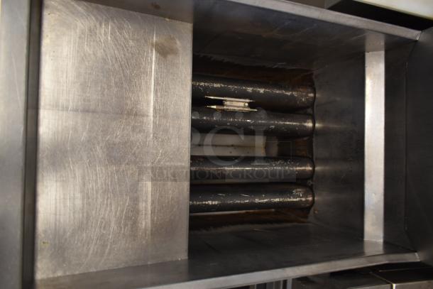 Industrial stainless steel food processor, showing inner drum with slight wear and markings. Suitable for bulk processing.