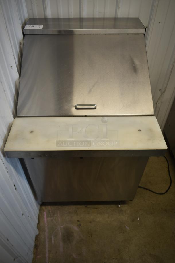 Stainless steel commercial ice bin, top lid, and handle, with cutting board attached. Auction tag labeled "106."