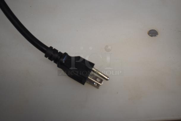 Black electrical power plug with a two-prong connector, in good condition, against a plain background.
