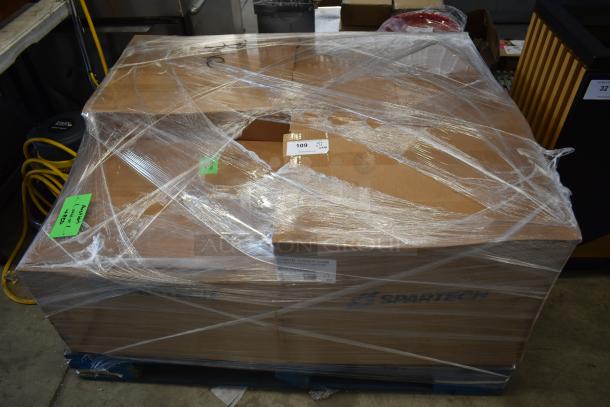 Large cardboard box on a pallet, wrapped in plastic, labeled "Canon Toner Com" and "Spartech." Tags indicate auction lot 109.