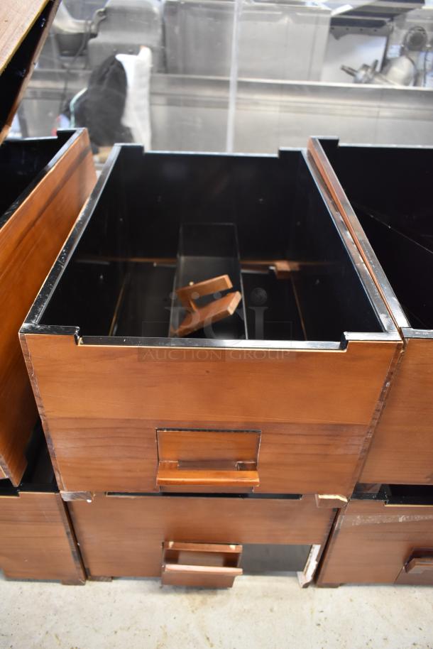 Wooden drawers with metal lining and handles, modular design, showing moderate wear; ideal for organizing or storage.