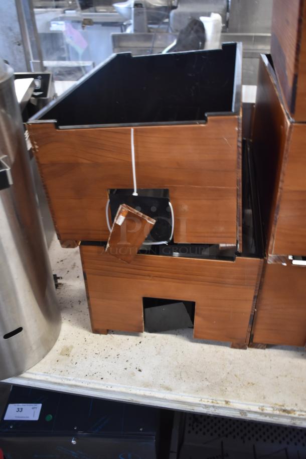 Wooden box with a broken section, metal interior lining, and a small hanging panel, suitable for storage or repair.