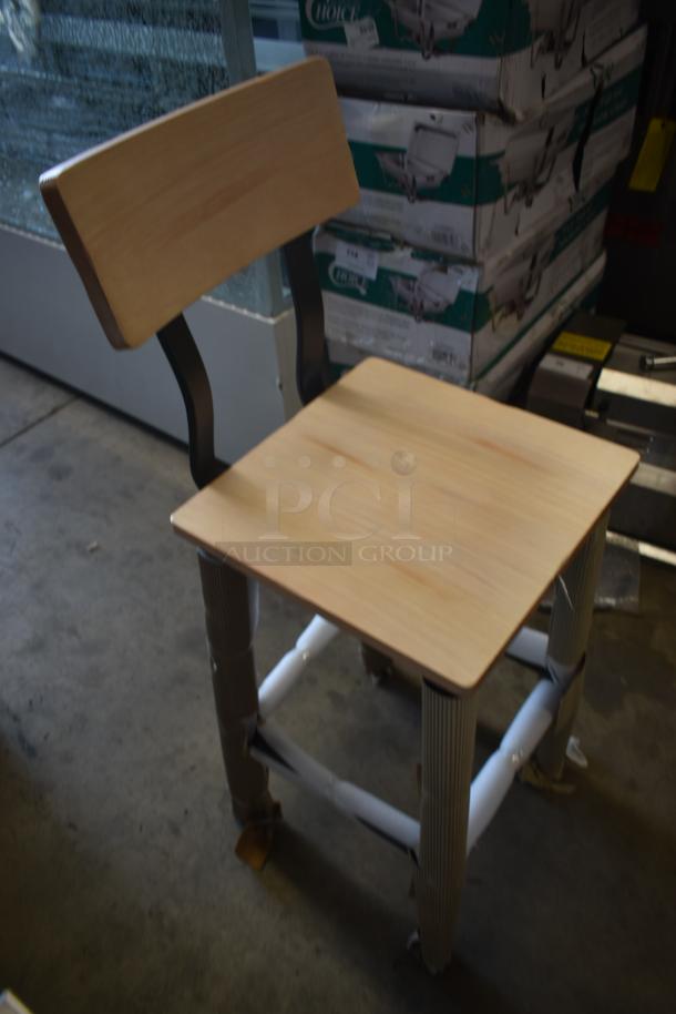 Wooden chair with metal supports and protective wrapping on legs, featuring a simple rectangular backrest and seat.