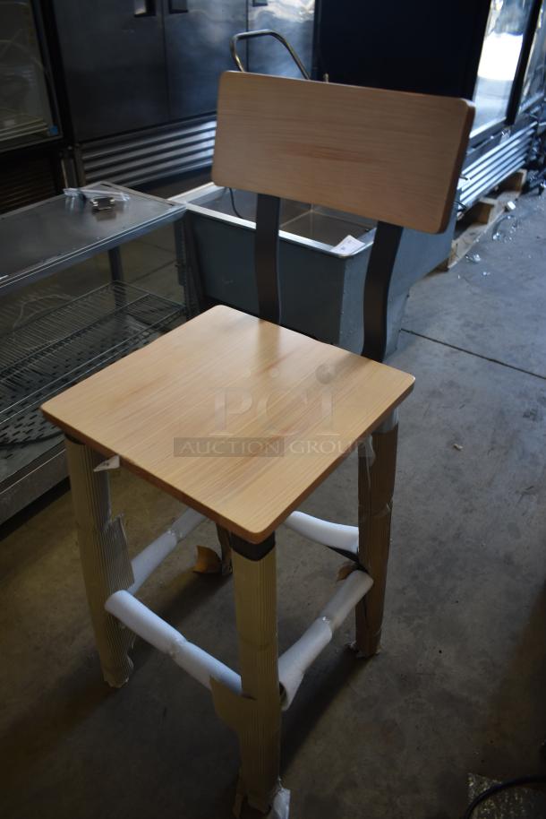 Wooden high chair with a natural finish, metal backrest, protective wrapping on legs, in new condition.