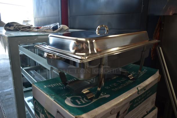 Stainless steel chafing dish on box, 8-quart capacity, with lid and handles, appears in good condition, no visible marks.