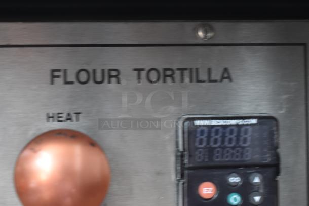 Control panel of a flour tortilla machine with heat dial and digital display. Markings indicate functional settings and website URL.