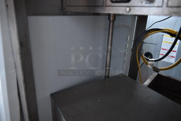 Industrial machine interior showcasing metal components, wiring, and control panel. Suitable for commercial use. Good condition.