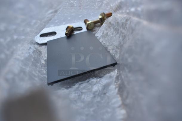 Metal mounting bracket with bolts on bubble wrap, new condition.