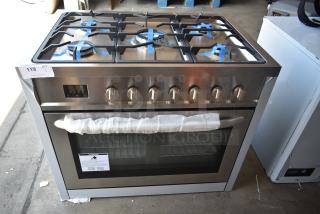 Stainless steel six-burner gas range oven with protective wrapping, tagged with auction number 119.