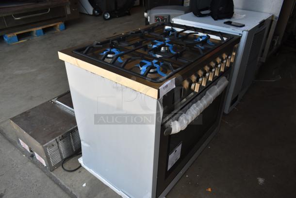 Stainless steel gas range with six burners, protective wrap on knobs, new condition, auction tag showing item 119.