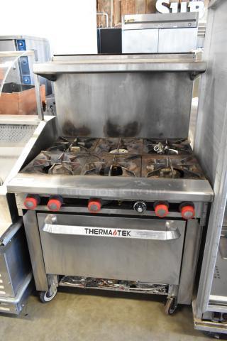 Thermatek Stainless Steel Commercial Natural Gas Powered 6 Burner Range w/ Oven, Over Shelf and Back Splash on Commercial Casters.