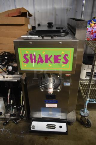 Commercial Taylor shake machine with a green "SHAKES" sign, in good condition. Model label visible.
