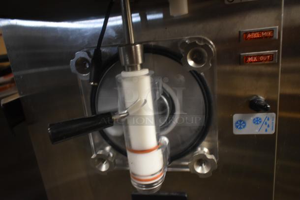 Soft-serve ice cream machine component with lever, visible adjustment knobs, and cooling symbols. Good condition.