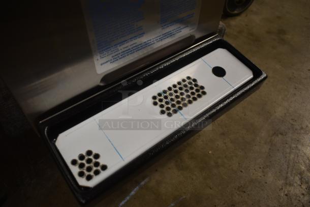 Stainless steel drip tray with perforated white insert, in excellent condition, suitable for commercial use.