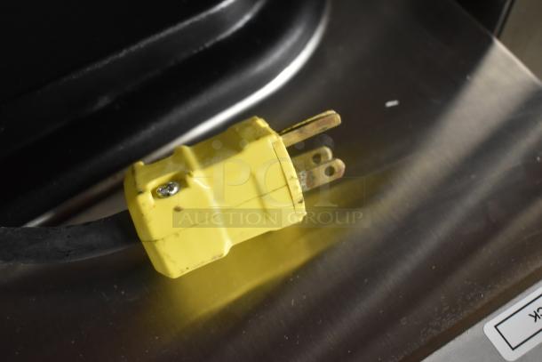 Yellow power cable with a grounded plug, showing wear. Suitable for heavy-duty use, no visible brand or label.