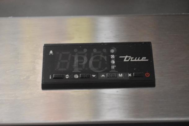 Digital control panel with "true" logo, displaying temperature settings. Black with multiple function buttons.